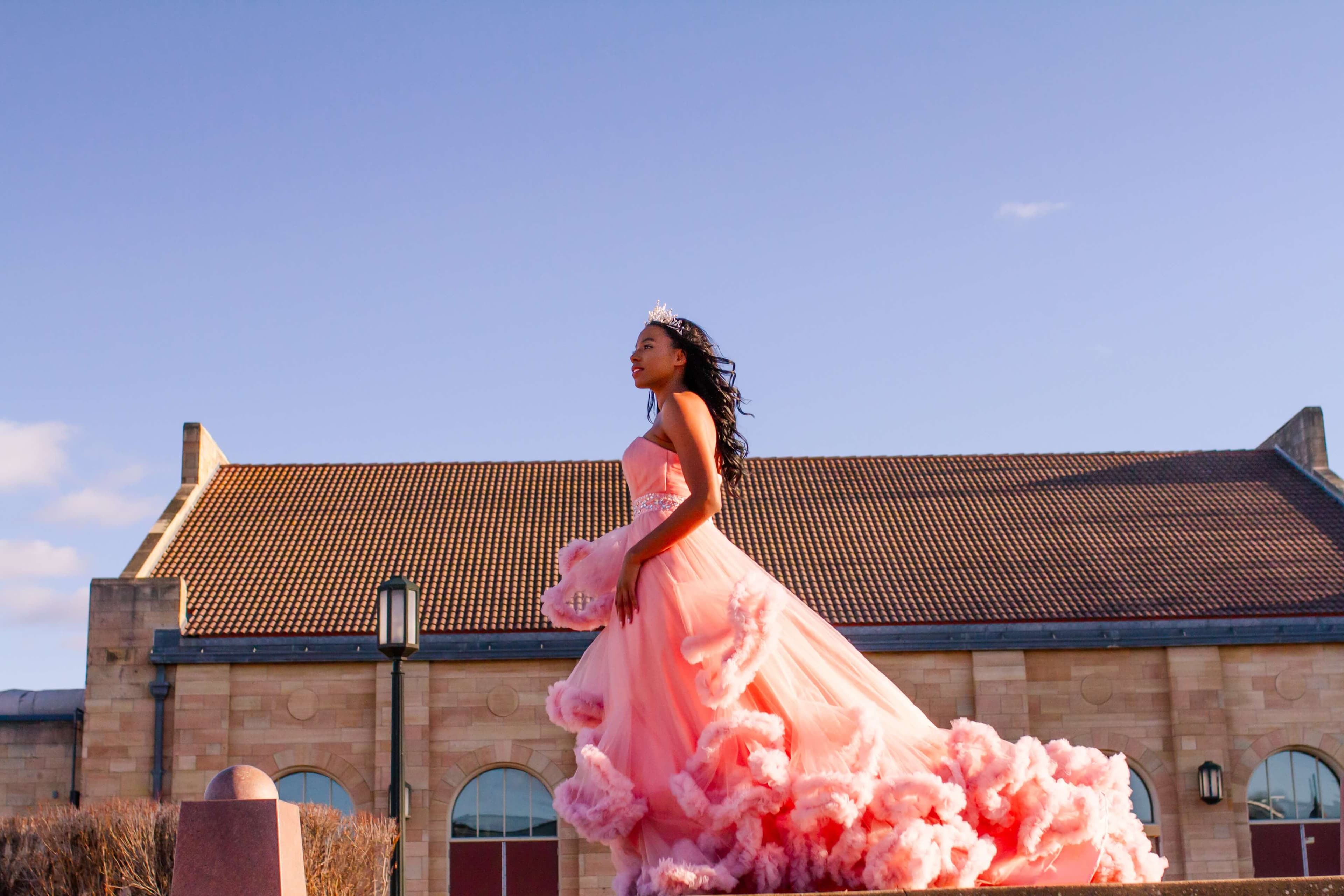 woman in bridal outfit posing next to church