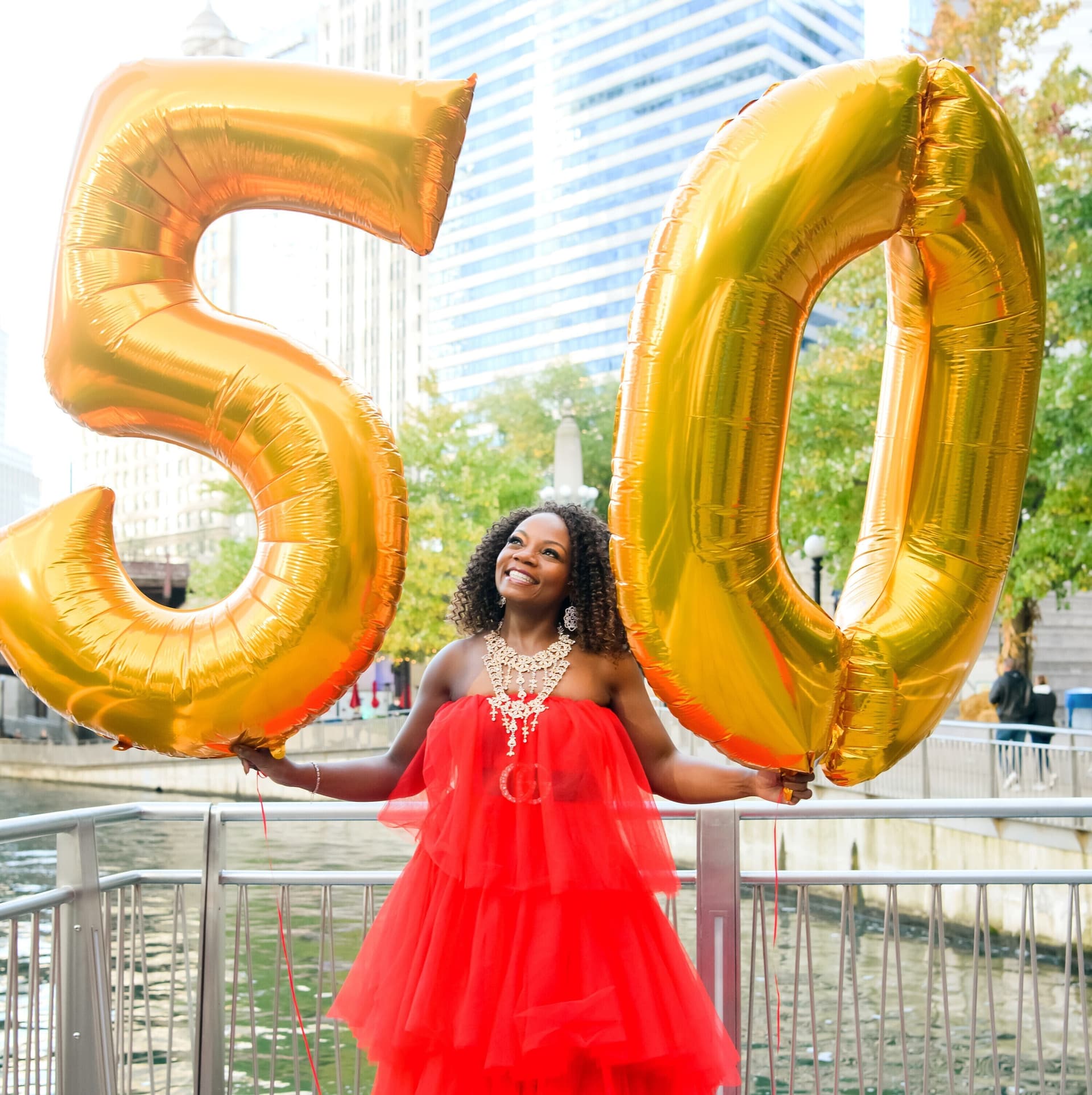 Birthday milestone portrait with large number balloons
