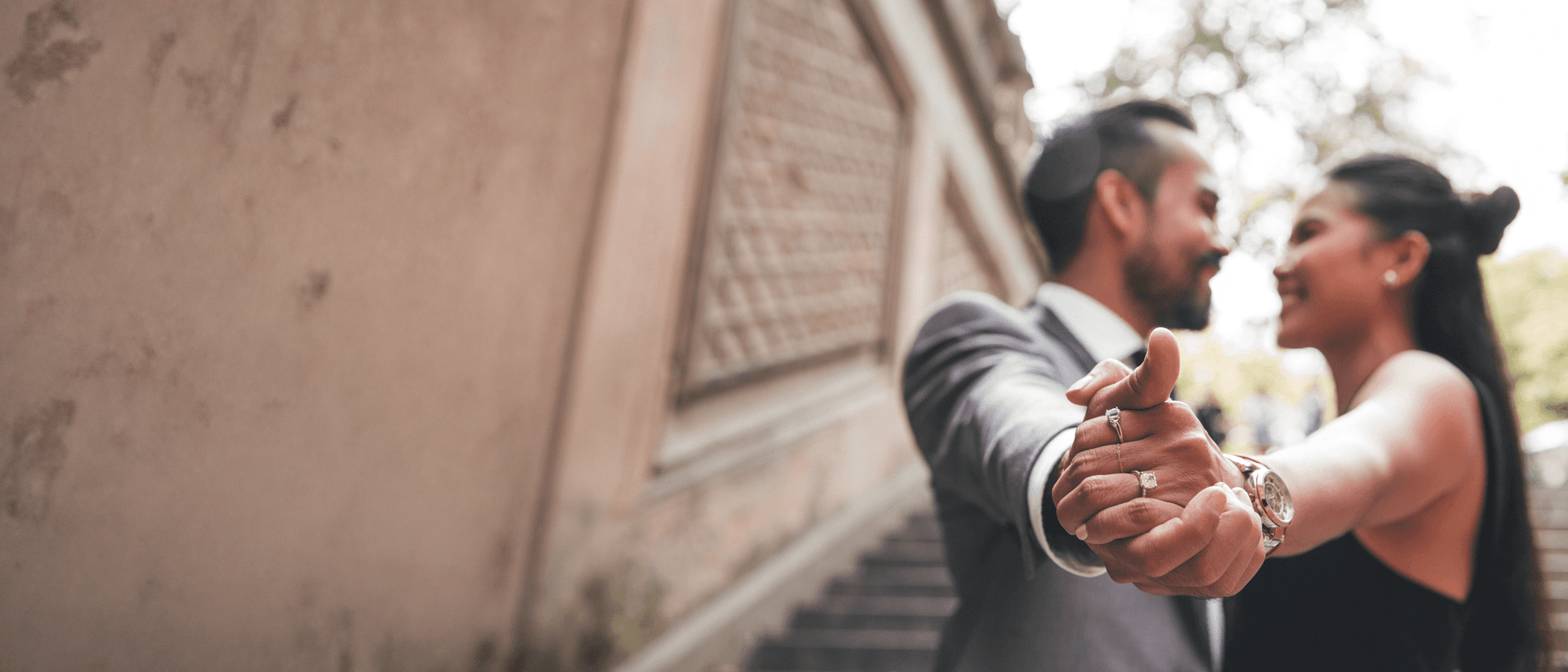 Engaged couple holding hands during an outdoor photoshoot