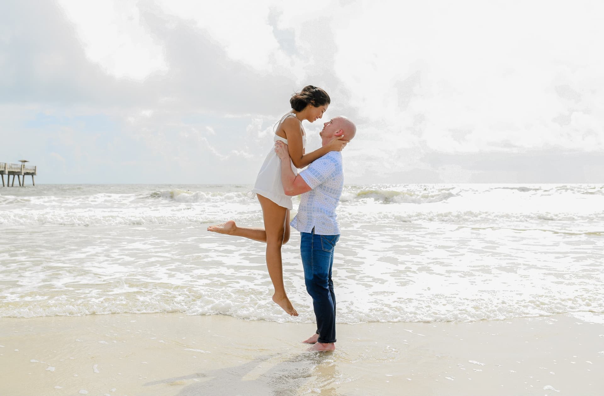 Couple posing together for a beach engagement portrait