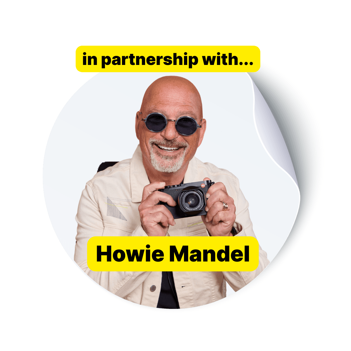 A pose of Howie Mandel with a camera to show his collaboration with Shoott
