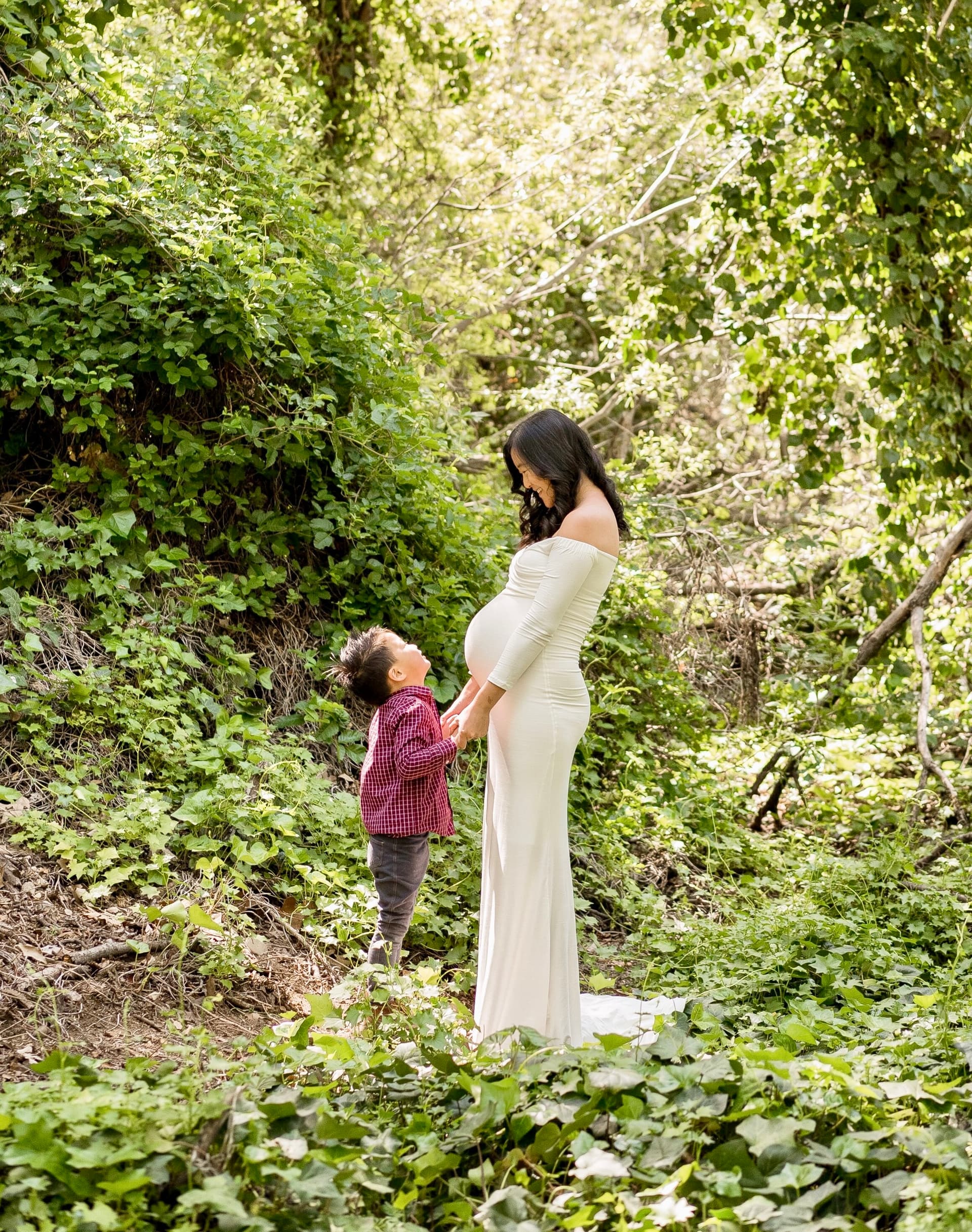 Expecting mother with child in a garden setting