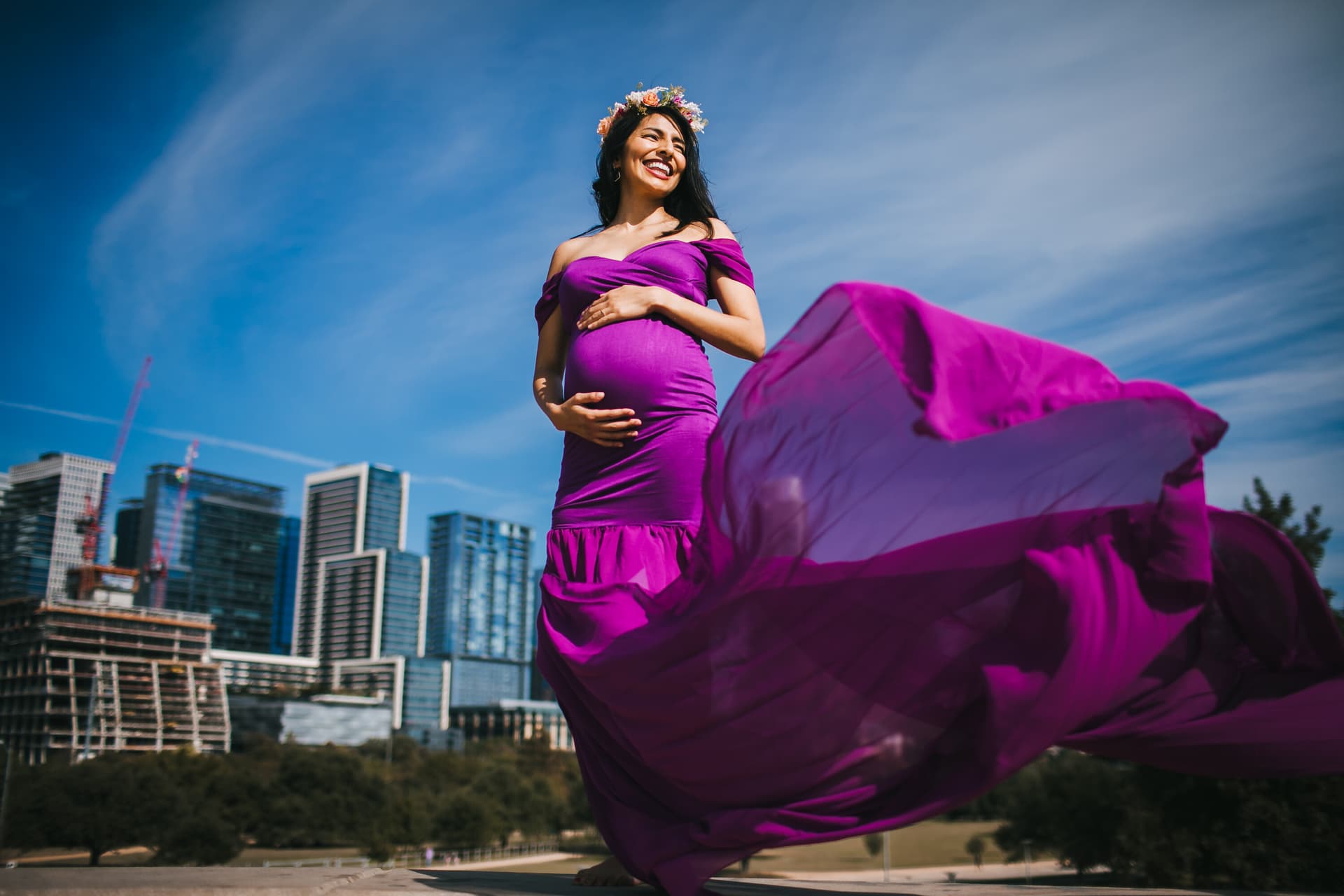 Expecting mother in a flowing dress posing outdoors