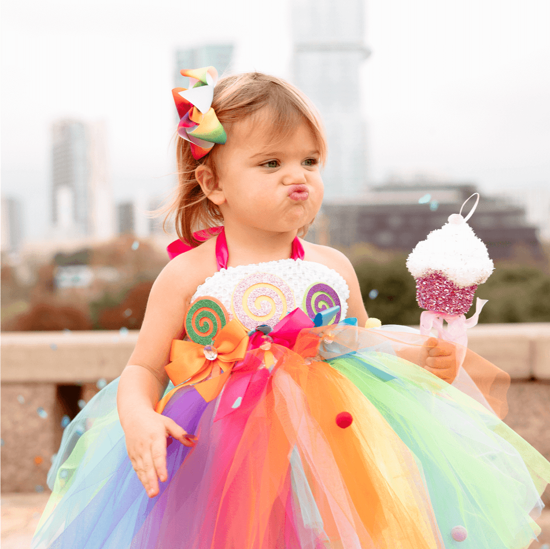 a girl holding an ice cream cone.