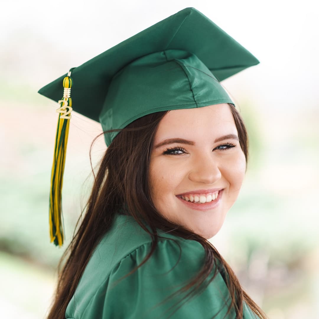 woman in a graduation outfit posing for a photo