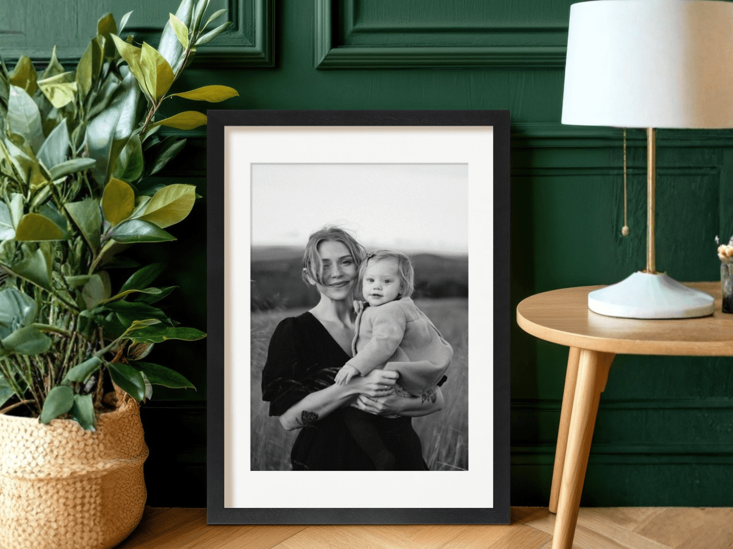 Paper Culture black-and-white framed print of a mother and child, displayed in a living room