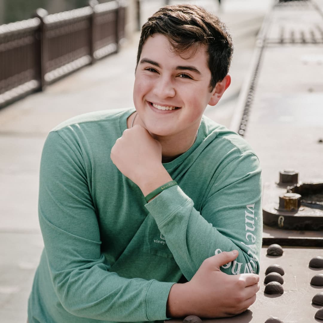 Boy poses outdoors for his free senior portrait photoshoot