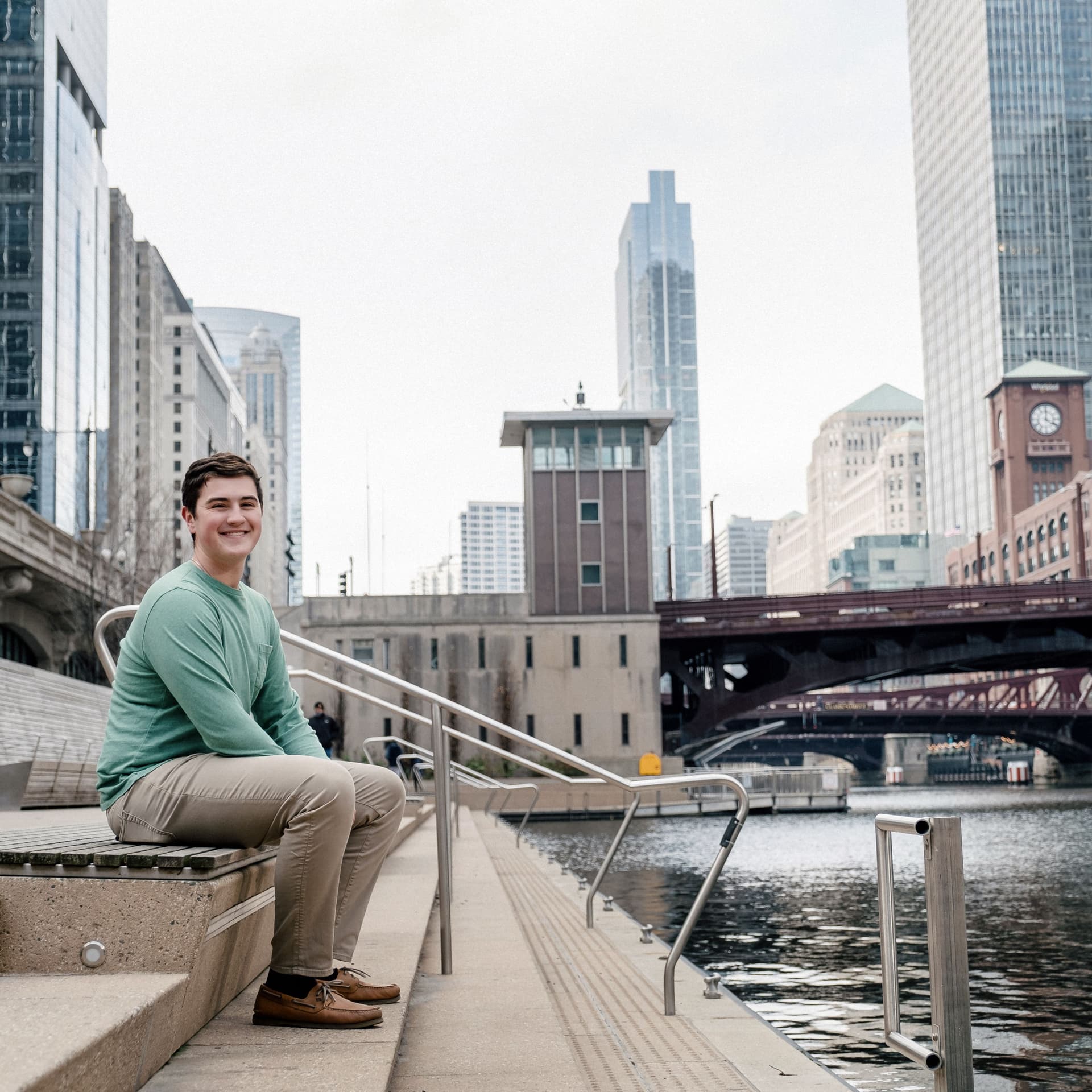Boy sits on stairs for his free outdoor senior portrait photoshoot