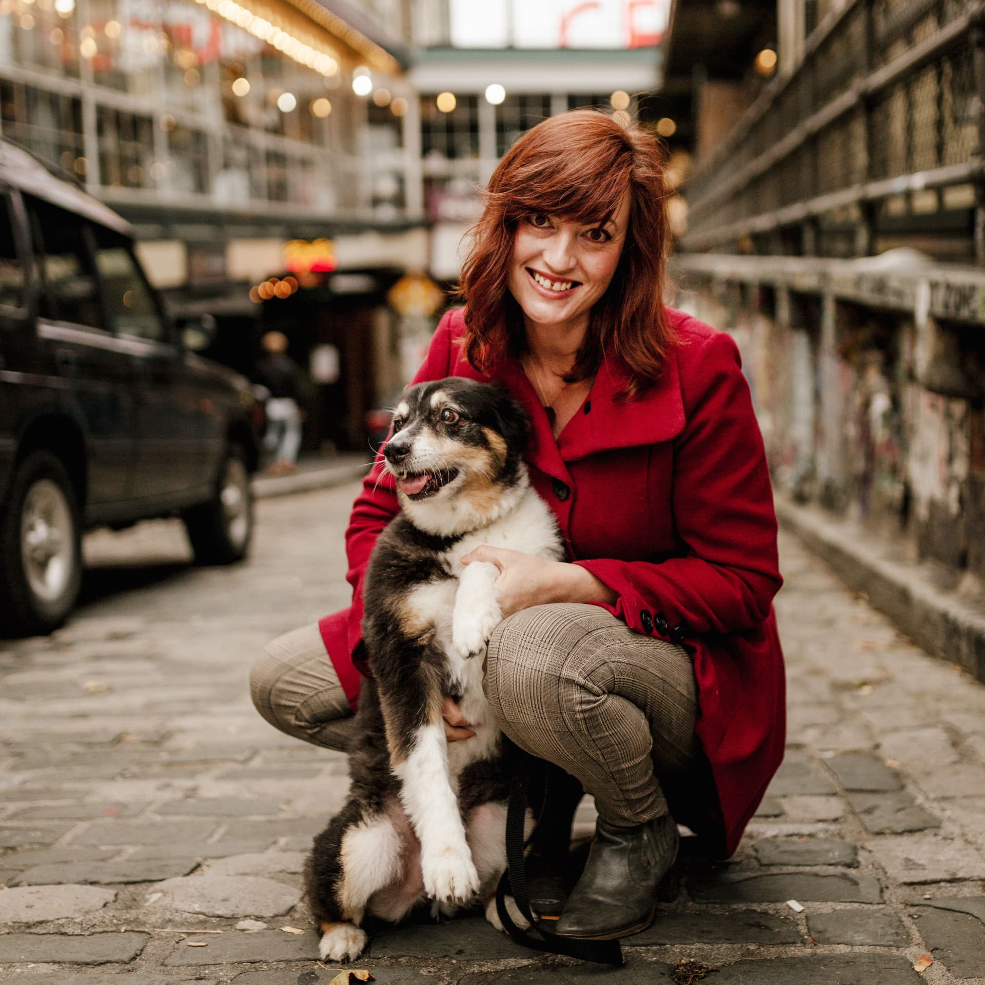 Woman holds her pet dog for her free outdoor photoshoot in the iconic public market