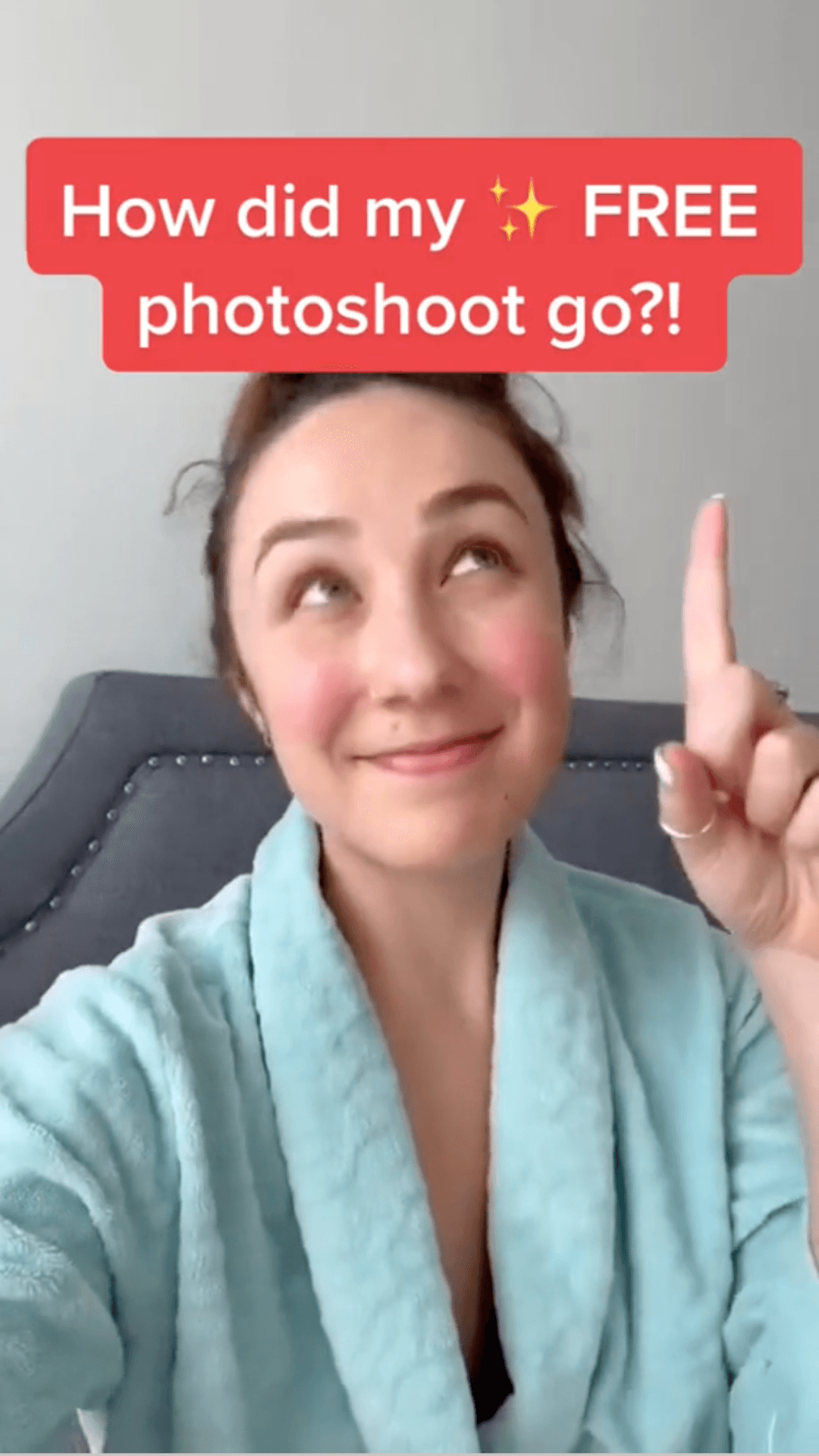 Woman in a blue robe pointing upward with text about a free photoshoot.