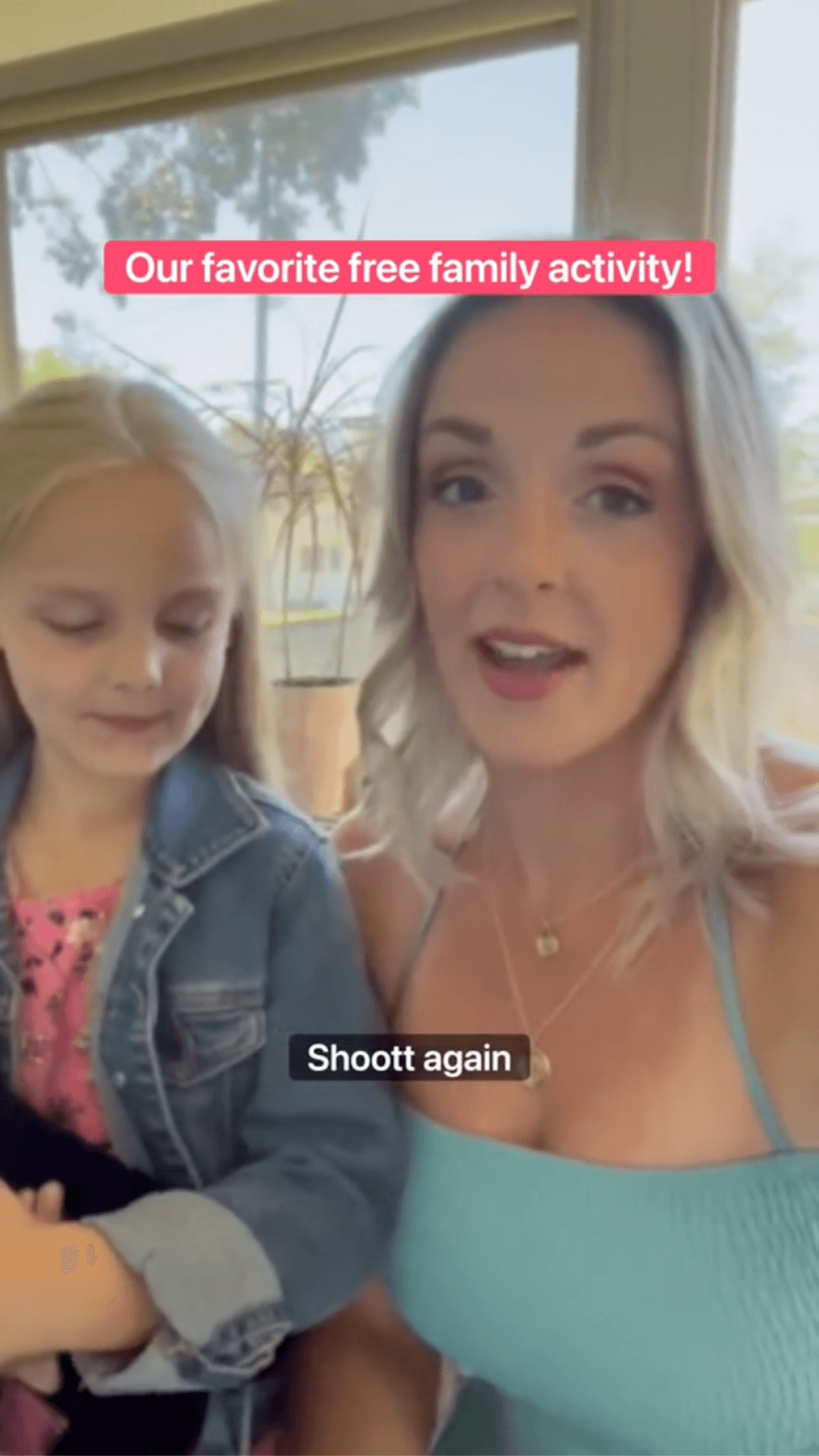 A woman and a young girl in a selfie video with text overlay reading "Our favorite free family activity!" and "Shoot again".