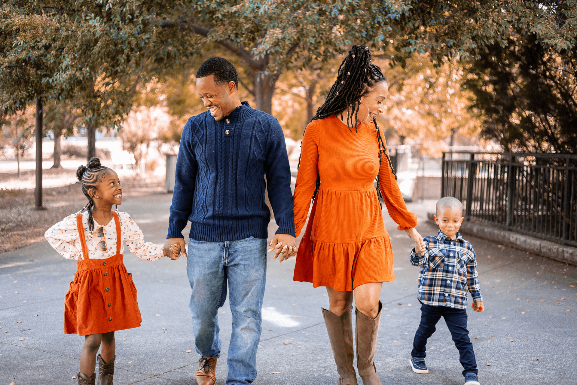 two people with two children posing in a playground