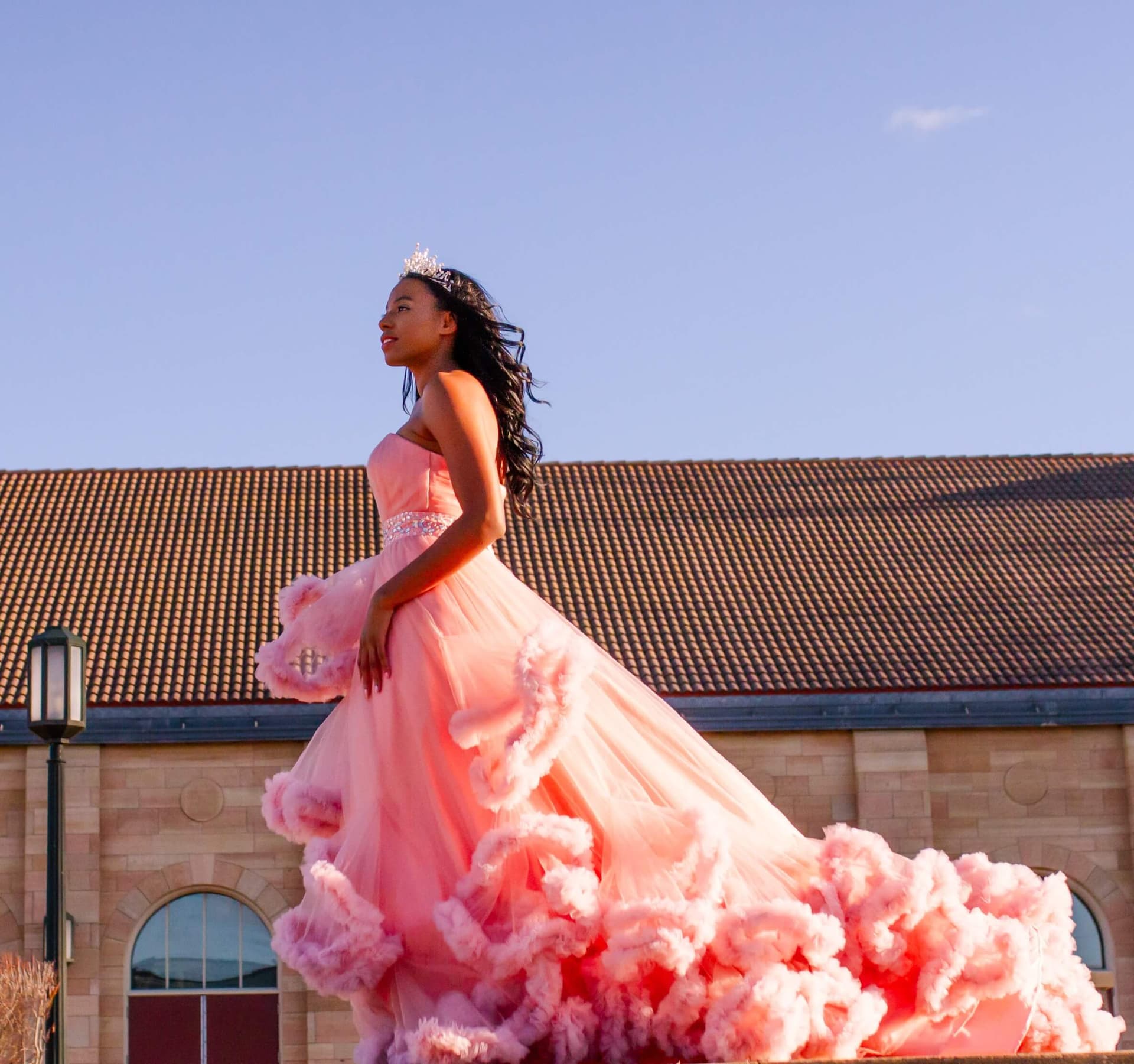 woman in bridal outfit posing next to church