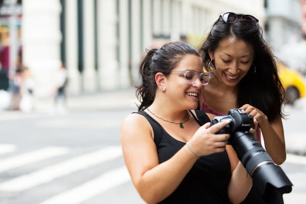 Photographer showing an image on her camera to a client.