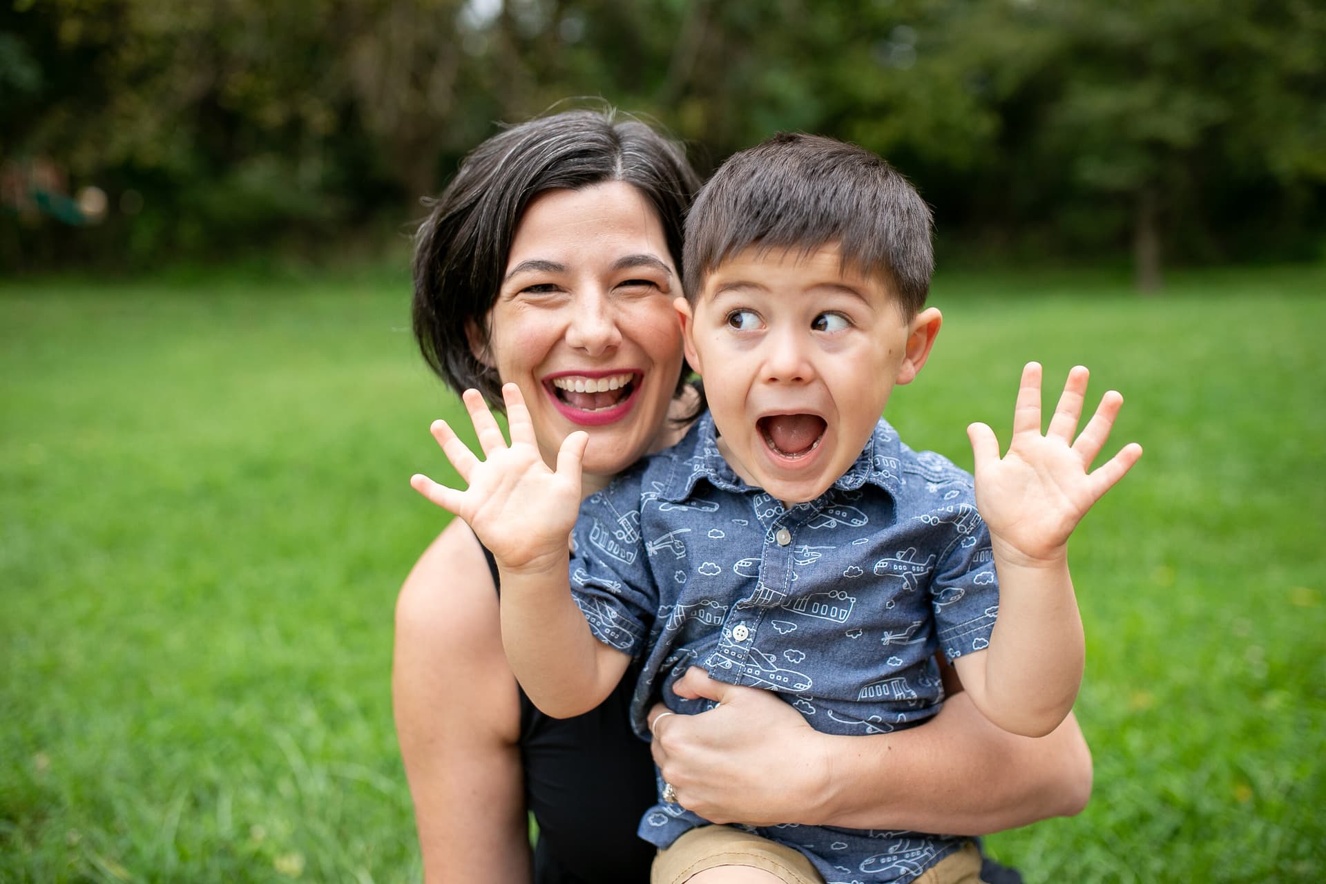 Mother and child laughing together in a park