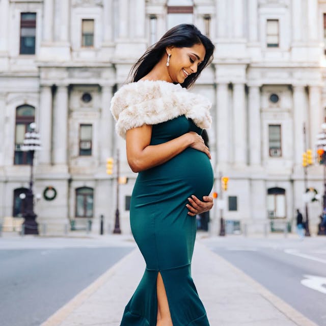 pregnant woman in a green dress for a maternity photoshoot