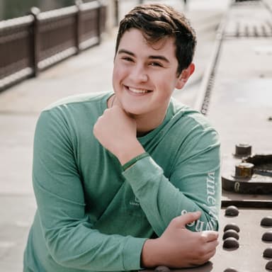 Boy poses outdoors for his free senior portrait photoshoot