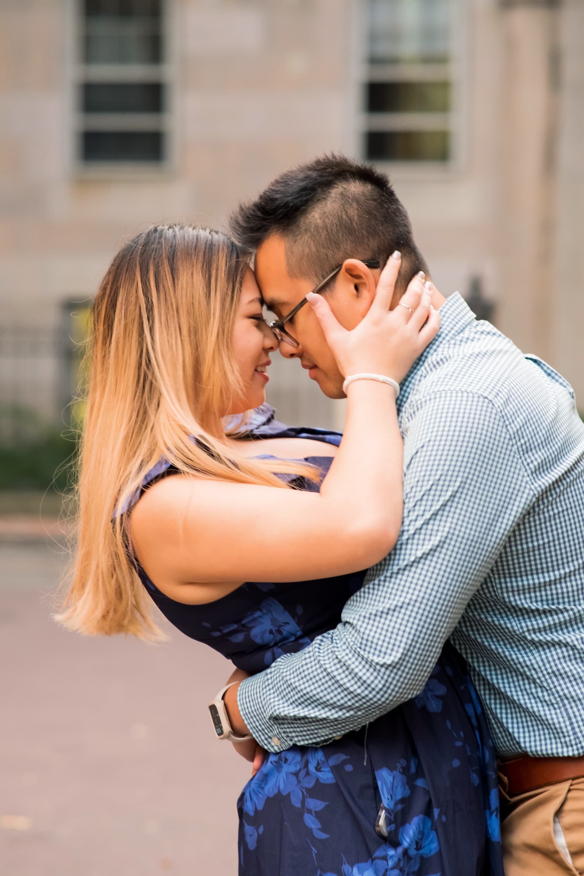 A couple embracing and touching foreheads affectionately.