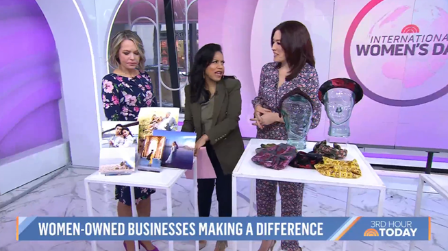 Three women standing at a display table with products during a segment about women-owned businesses making a difference for International Women's Day on the 'TODAY' show.