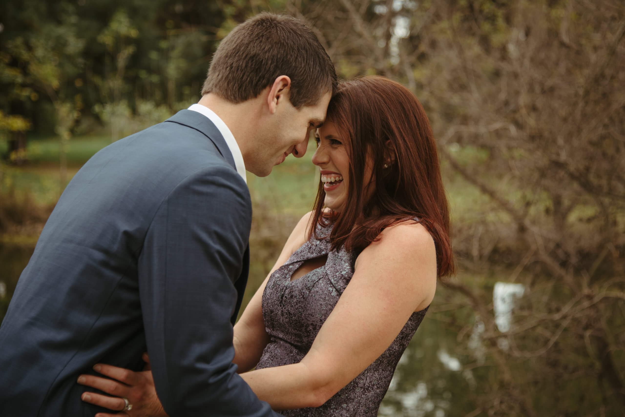 Man and woman leaning in close with their foreheads touching and smiling