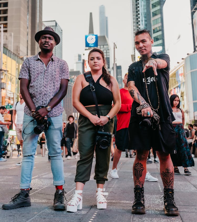 3 professional photographers pose in Times Square NYC