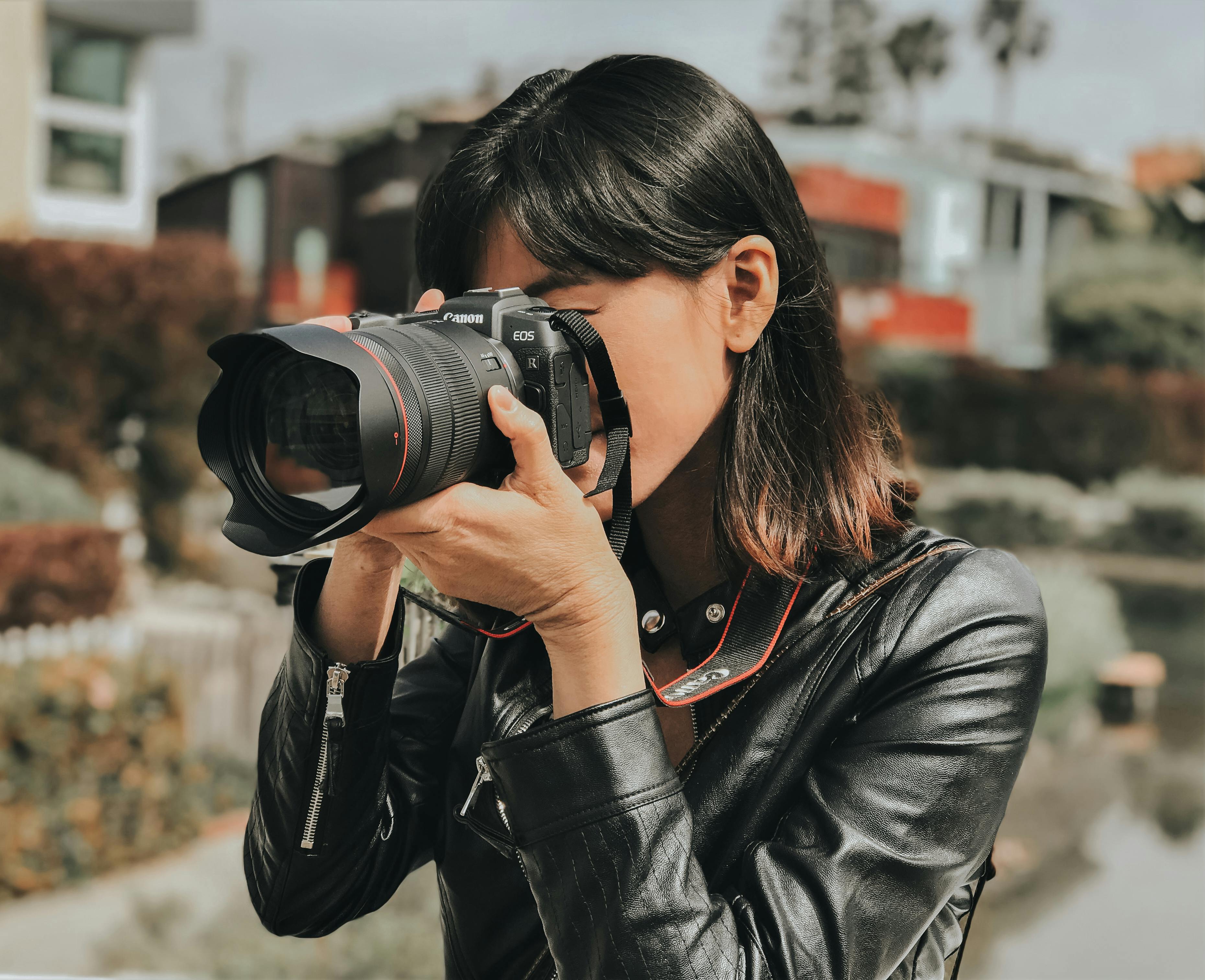 A woman photographs with a professional camera.