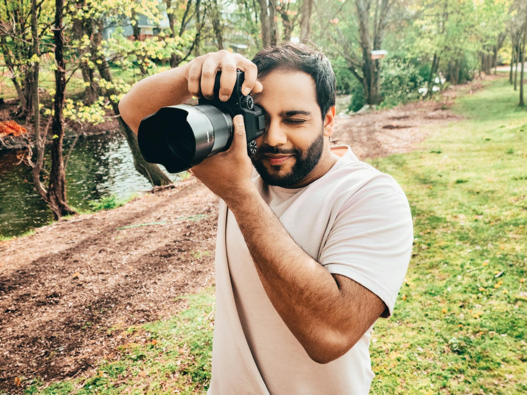 Man taking photos with a DSLR camera outdoors.