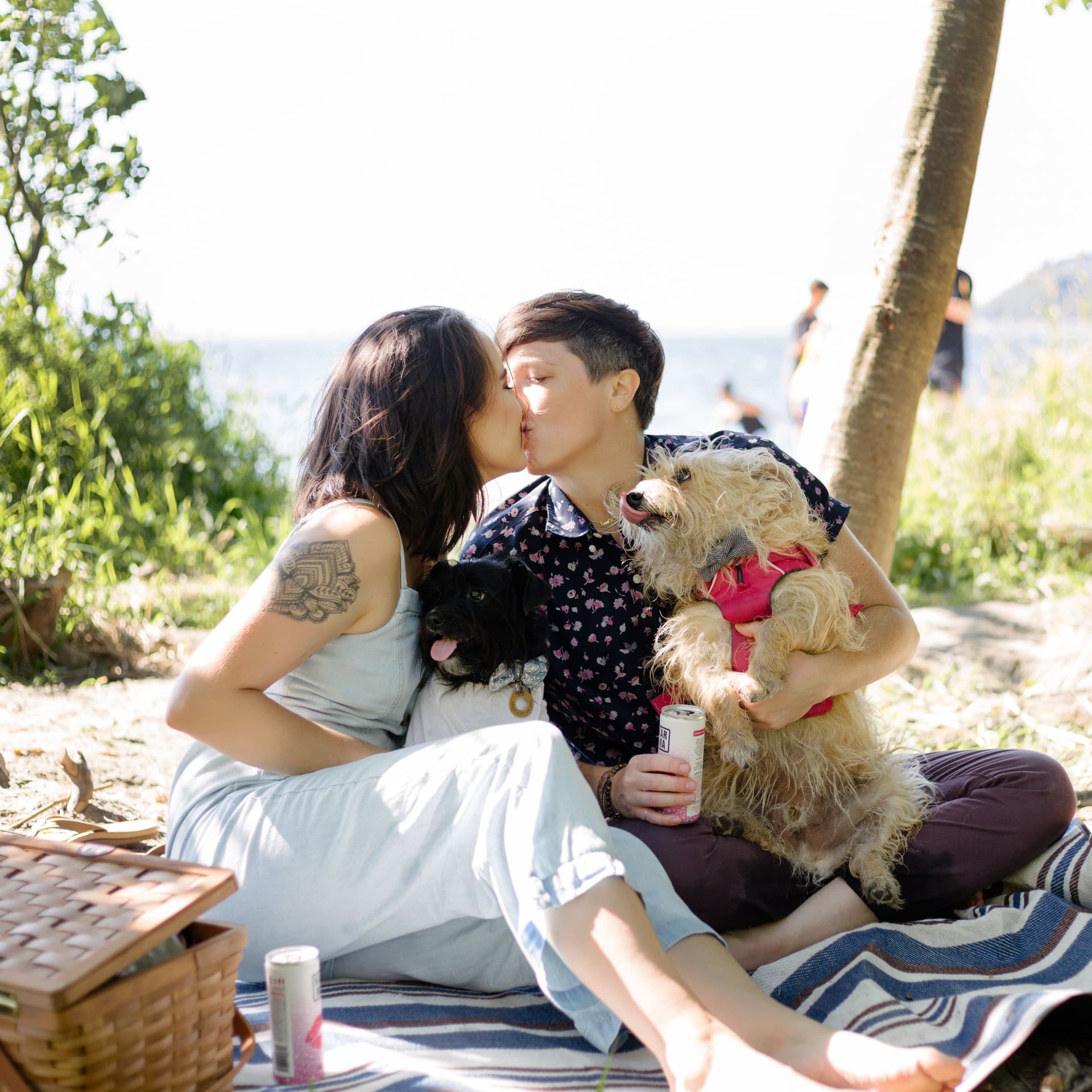 Laughing couple hold each other for their free beach couple photoshoot